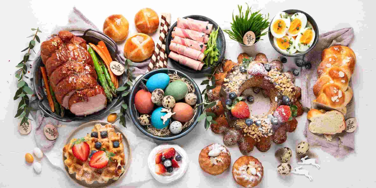 Easter hosting table with drinks snacks chocolates and multicultural foods setup