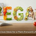 Colourful vegan and vegetarian meal ingredients featuring rice, lentils, beans, vegetables, plantain, noodles, spices, and world foods arranged on a kitchen table, showcasing easy everyday meal ideas for healthy plant-based eating.